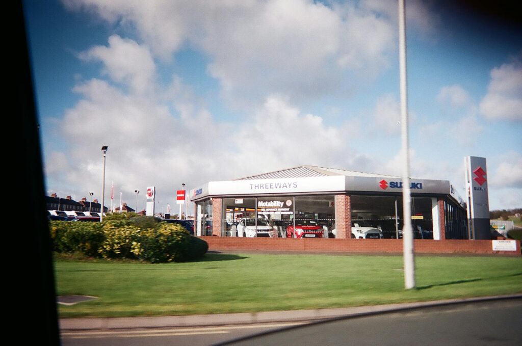 Used car vs new car — exterior of a new car dealership