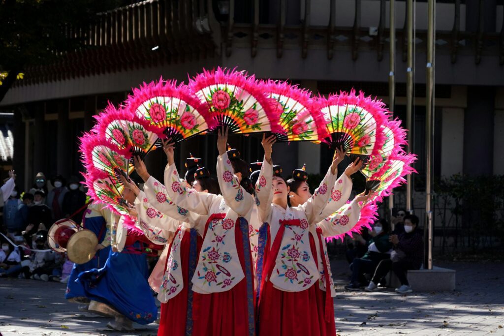 Korean talchum mask dance paired with a folk percussion stage — colorful outdoor stage at the Andong International Mask Dance Festival