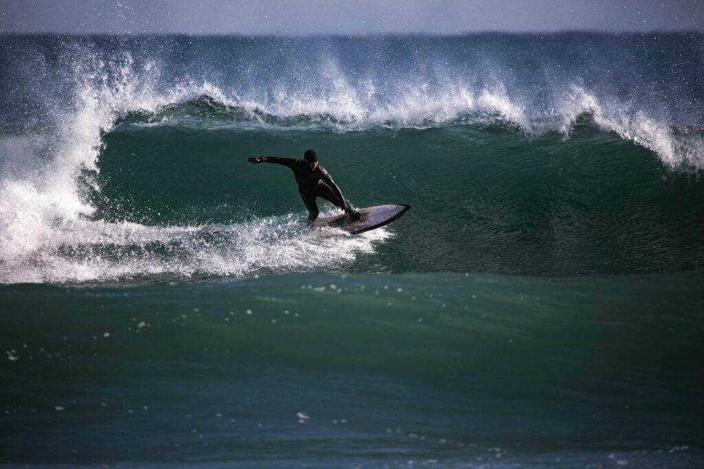 Yangyang surfing spot — a single surfer riding a wave at a Yangyang beach (Pexels)